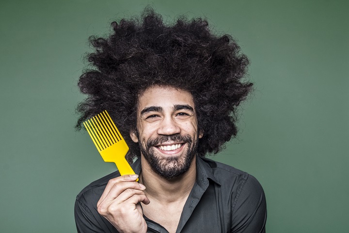 Man Holding Yellow Comb