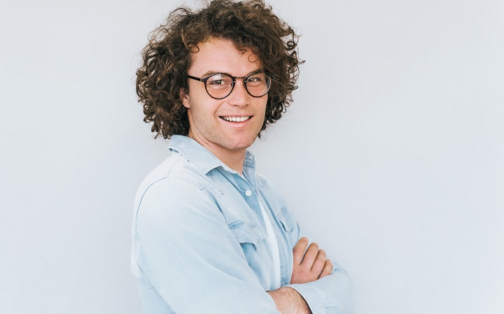 Smiling Young Man With Curly Hair Posing