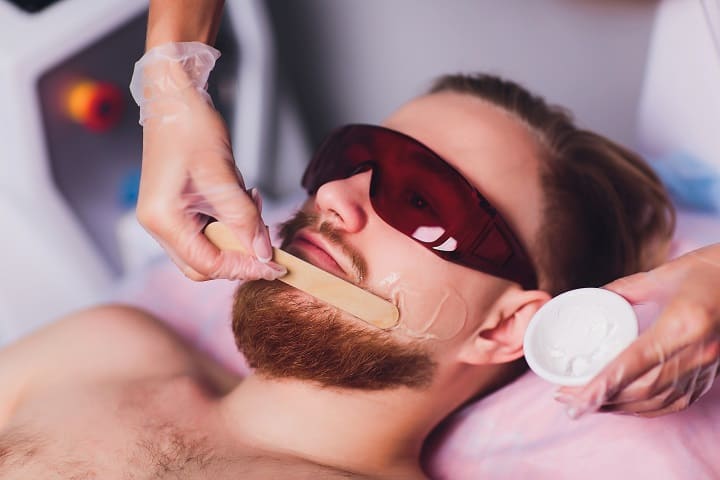 Applying Wax to a Man’s Beard