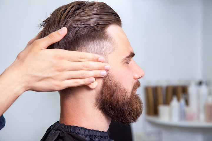 Bearded Man With an Undercut Sitting in a Barbershop