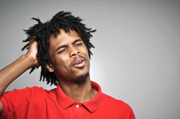 Black Guy With Twisted Hairstyle Touching His Hair