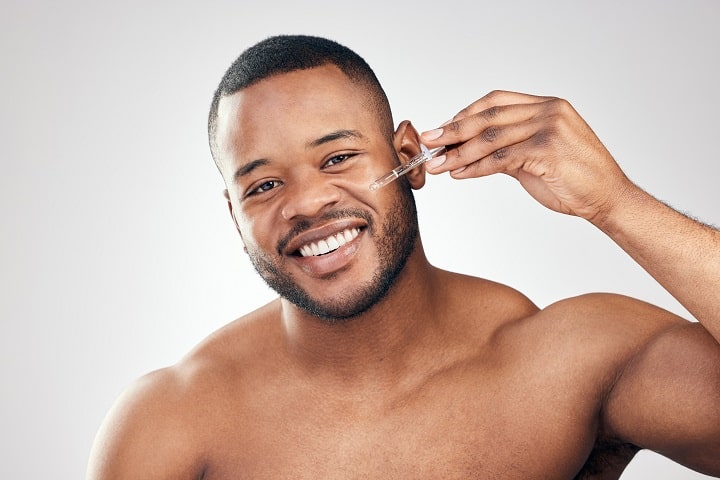 Black Man Appliying Beard Oil