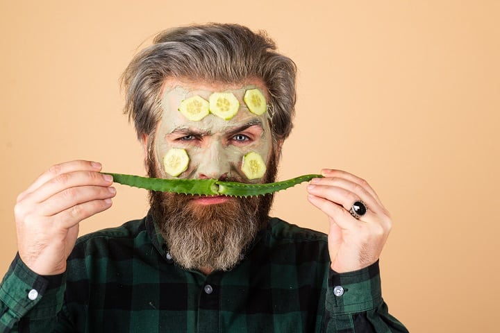 Bearded Man With Facial Mask and Aloe Vera