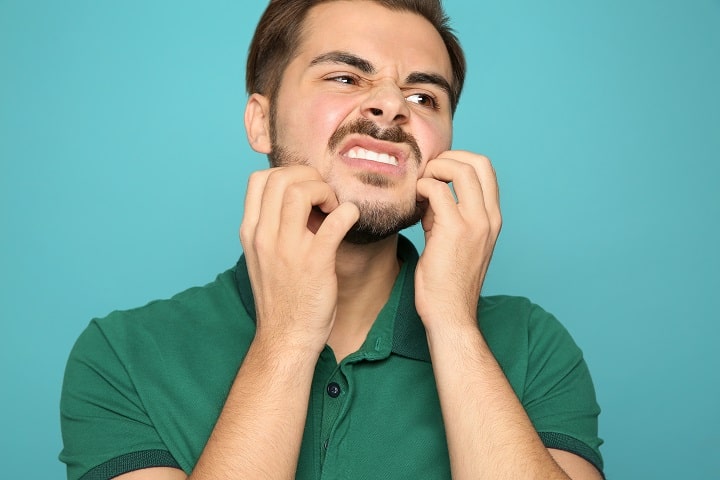 Man Scratching His Beard