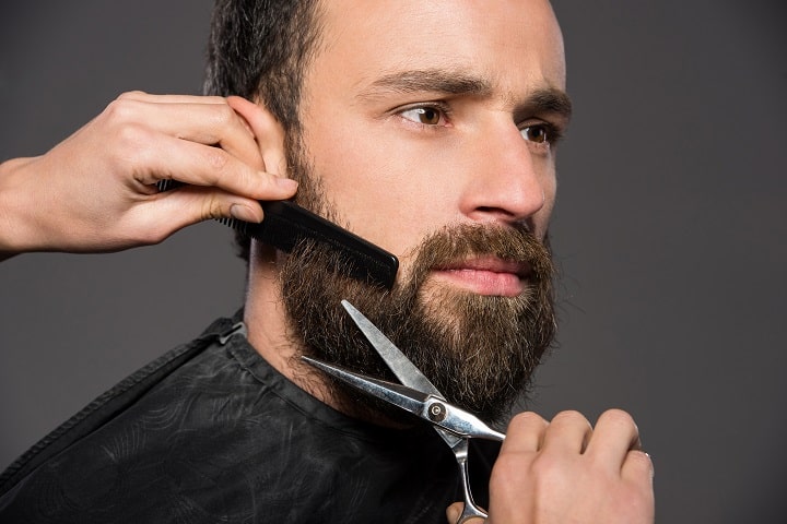 Man Is Trimming a Beard