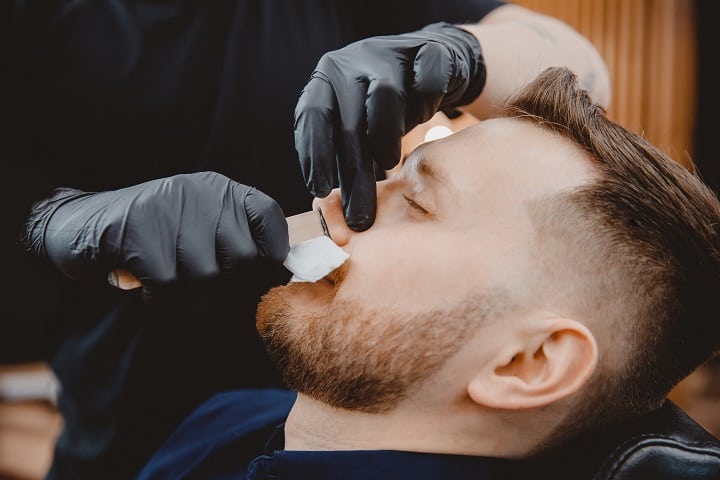 Barber Waxing Man's Beard and Nose Hair