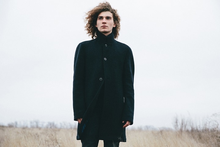 Man With Curly Hair Wearing Black Coat