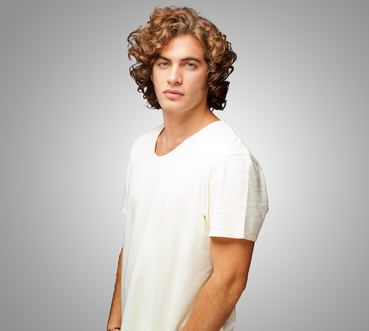 Young Man in White Shirt With Short Curly Hair